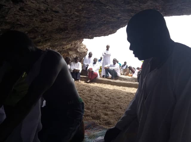 Gathering at the cave mouth
