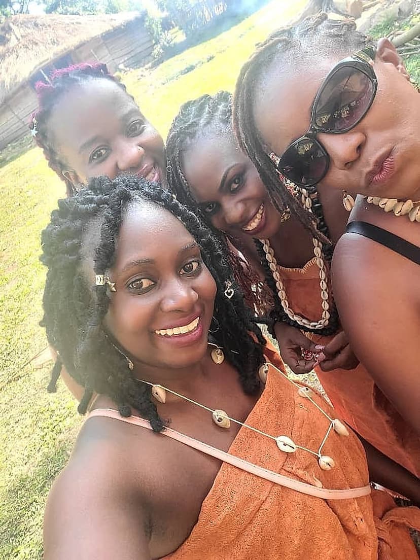 Four women wearing cowrie strand necklaces