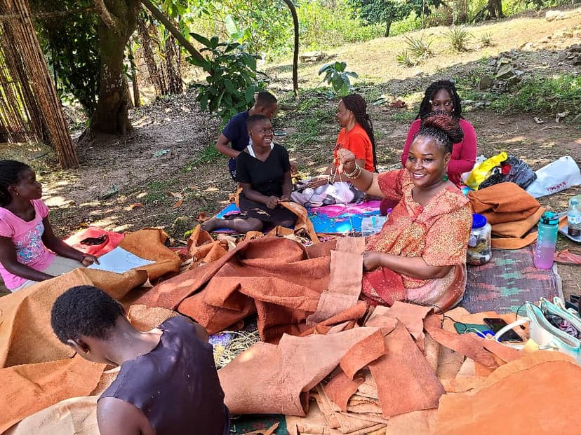 Workshop circle with sheets of olubugo bark cloth
