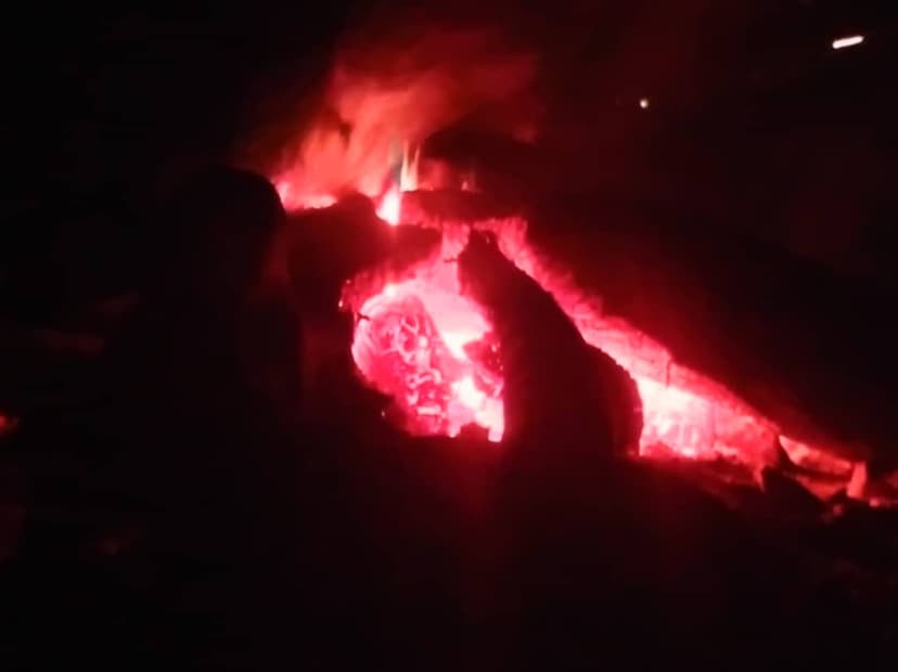 Low embers glowing on the shore fire