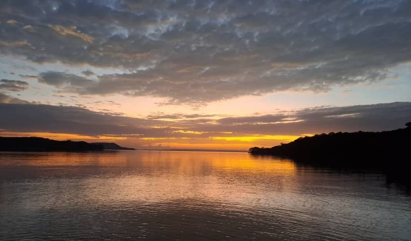 Golden sunset on calm Lake Victoria water